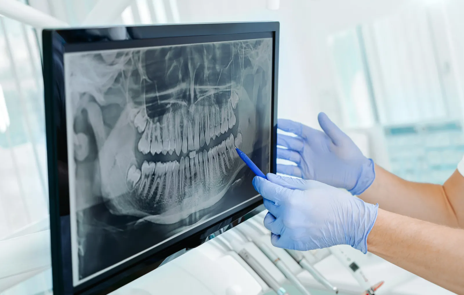 Friendly dentist smiling with checkmark/shield motif